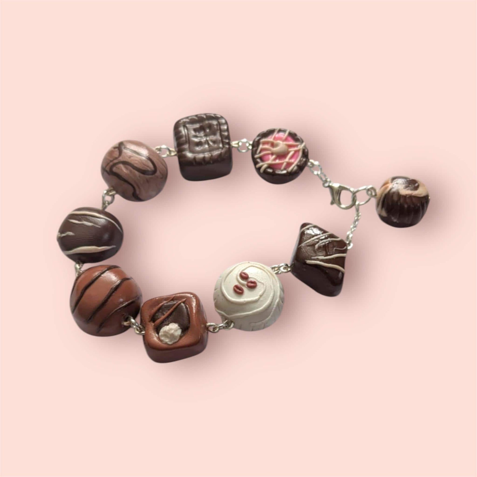 Bracelet with chocolate truffle-shaped beads on a pink background