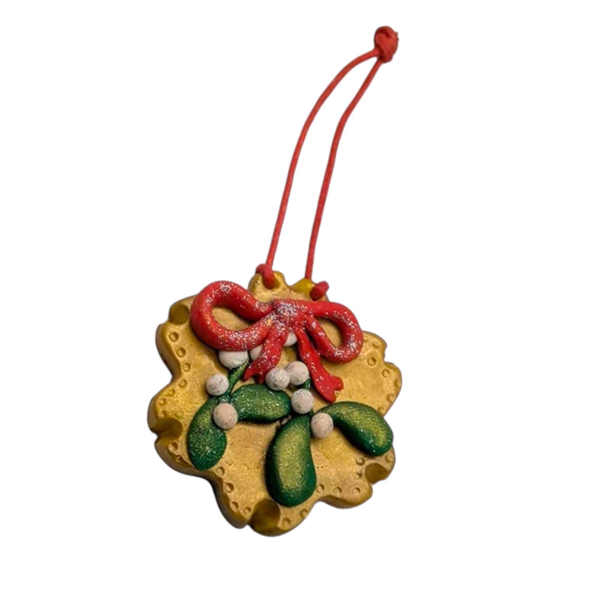 Decorative Christmas ornament with mistletoe design on a white background