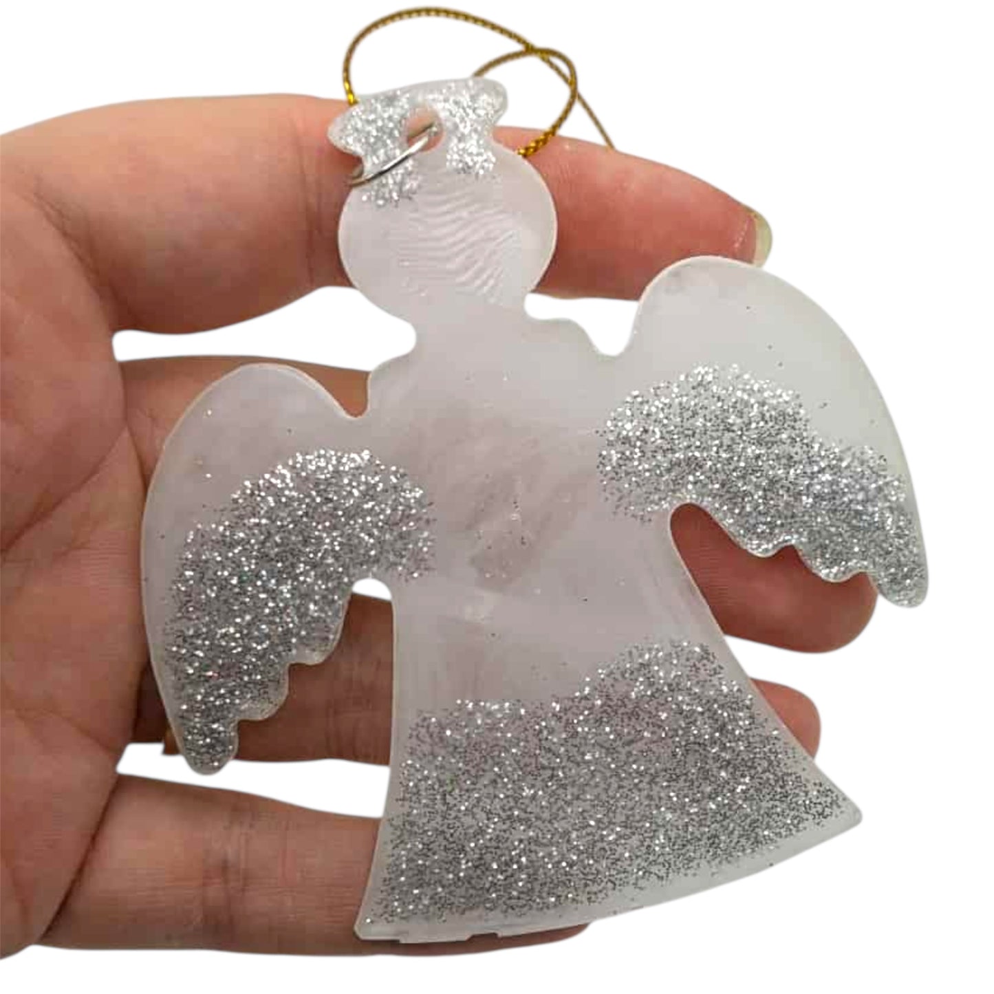 White angel ornament with silver glittery accents held in a hand against a white background