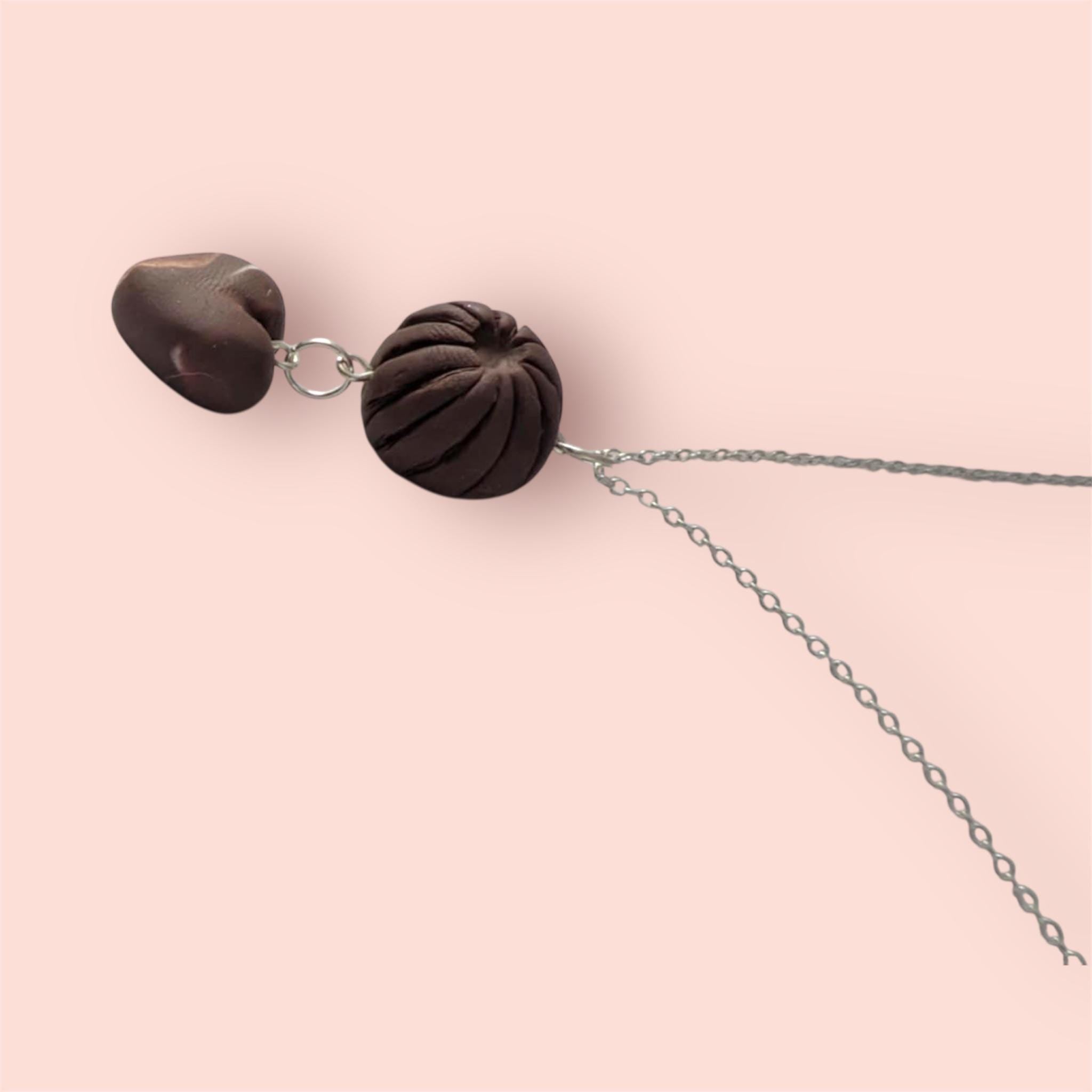 Brown mini chocolate necklace fake food clay necklace with silver chain on a pink background 