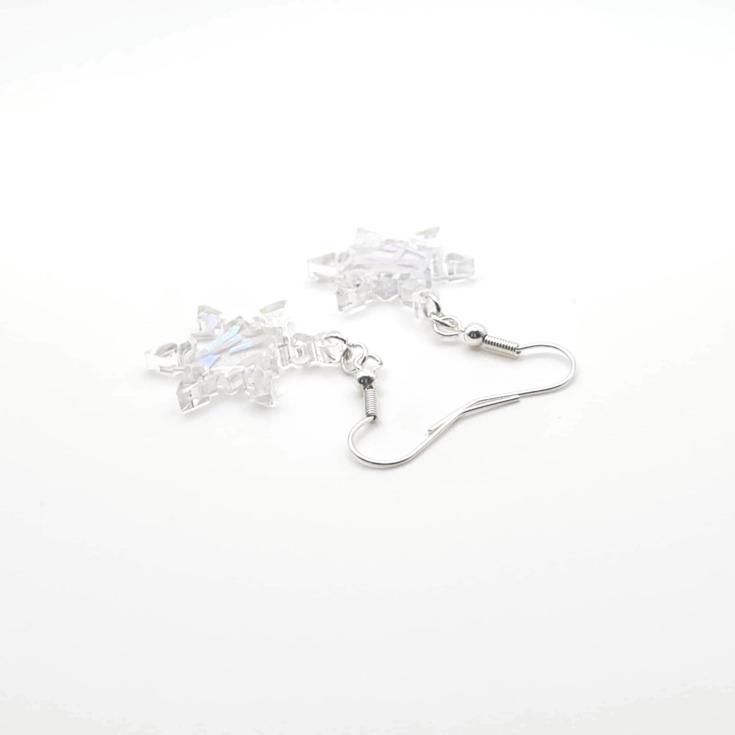 Star-shaped earrings with clear stones on a white background