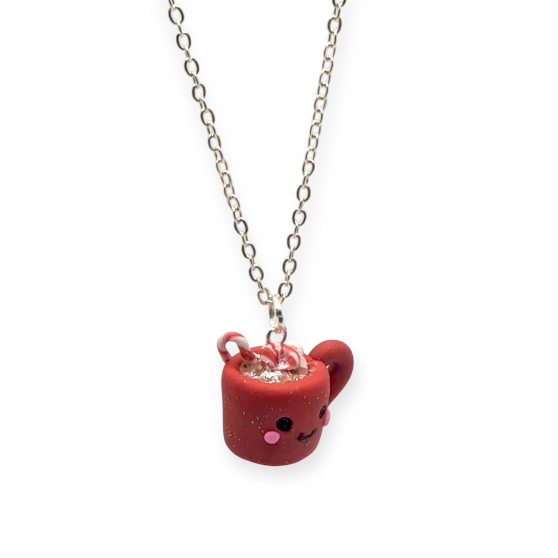 Red Christmas cocoa mug pendant hanging on silver chain on white background 