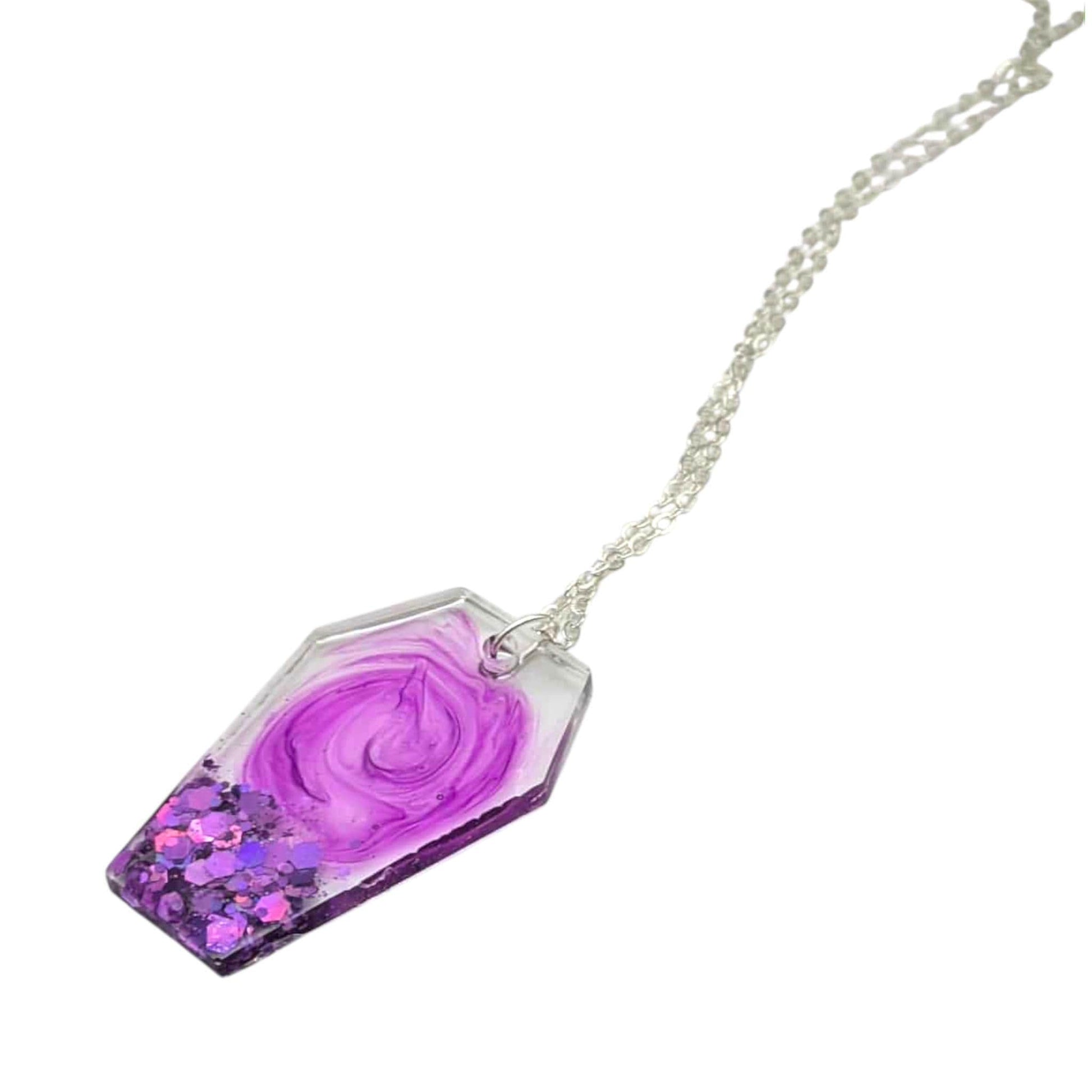 Necklace with a purple swirl-shaped pendant on a white background