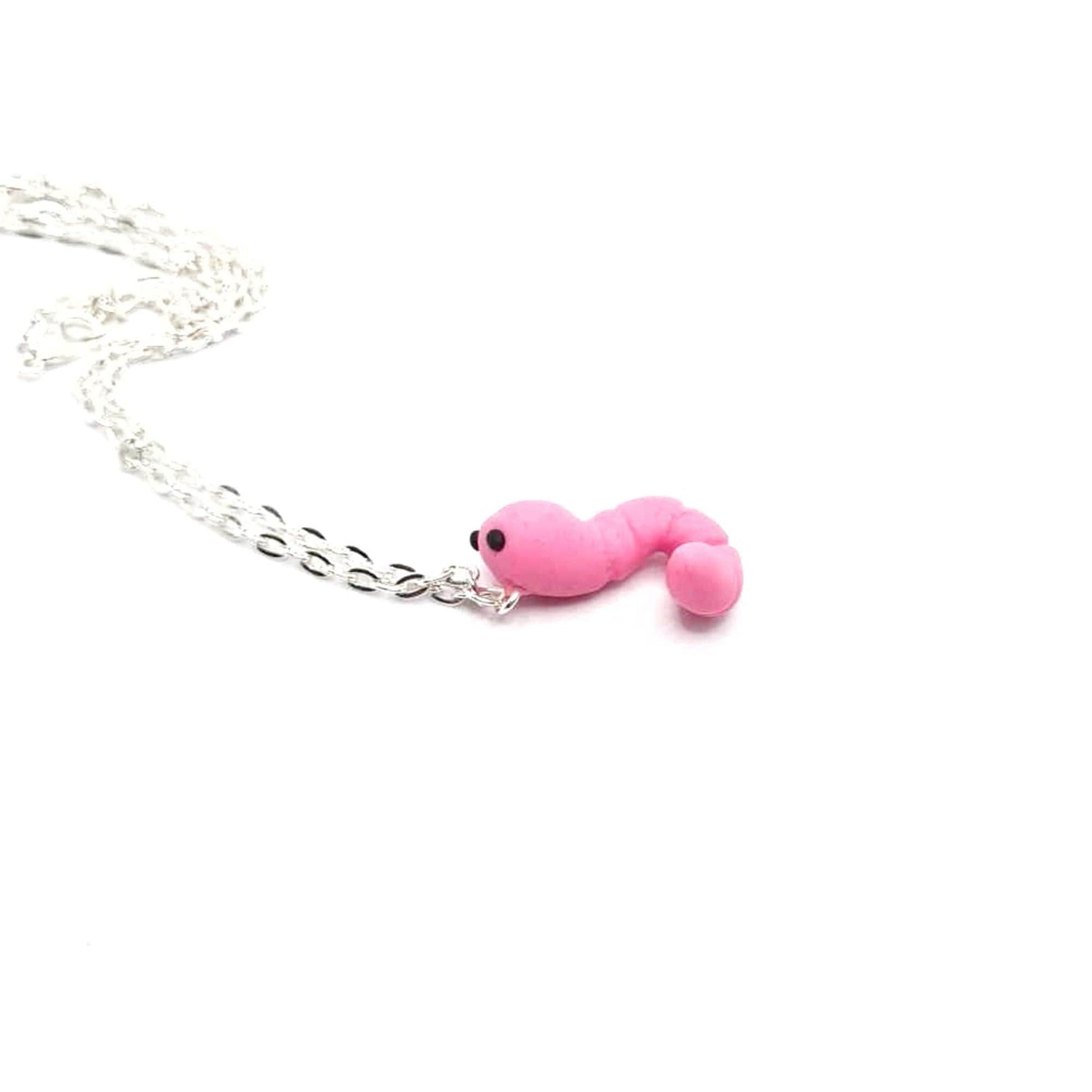 Pink snake-shaped charm on a silver chain against a white background