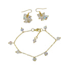 Cluster earrings and simple gold bracket on white background 