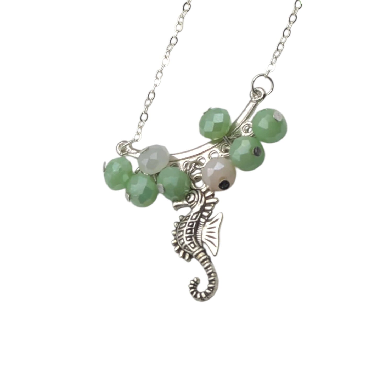 Handmade silver crystal seahorse necklace on white background 