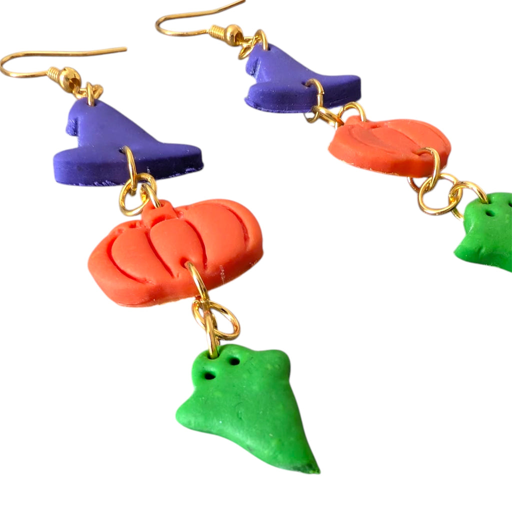 Colorful pumpkin-shaped earrings on a white background