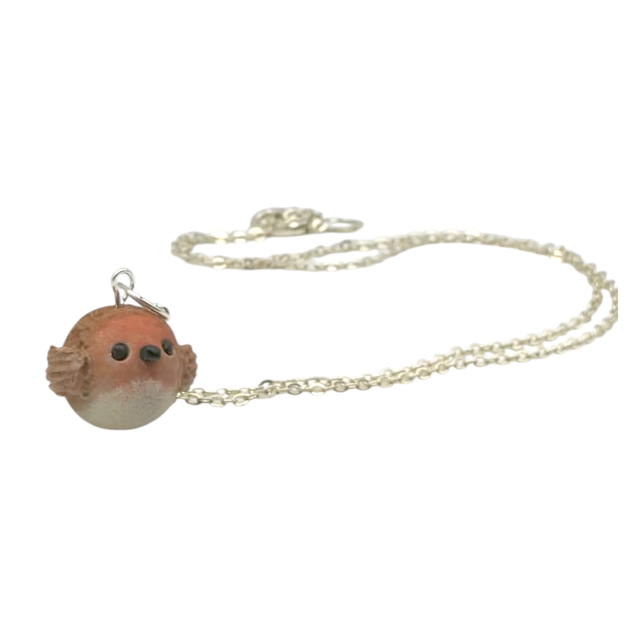 Handmade robin bird pendant necklace side view with silver chain on white background