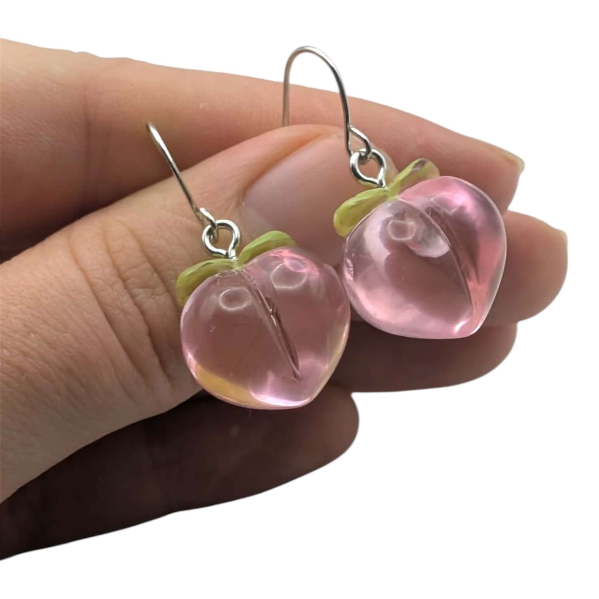 Cute kawaii peach earrings on a white background 
