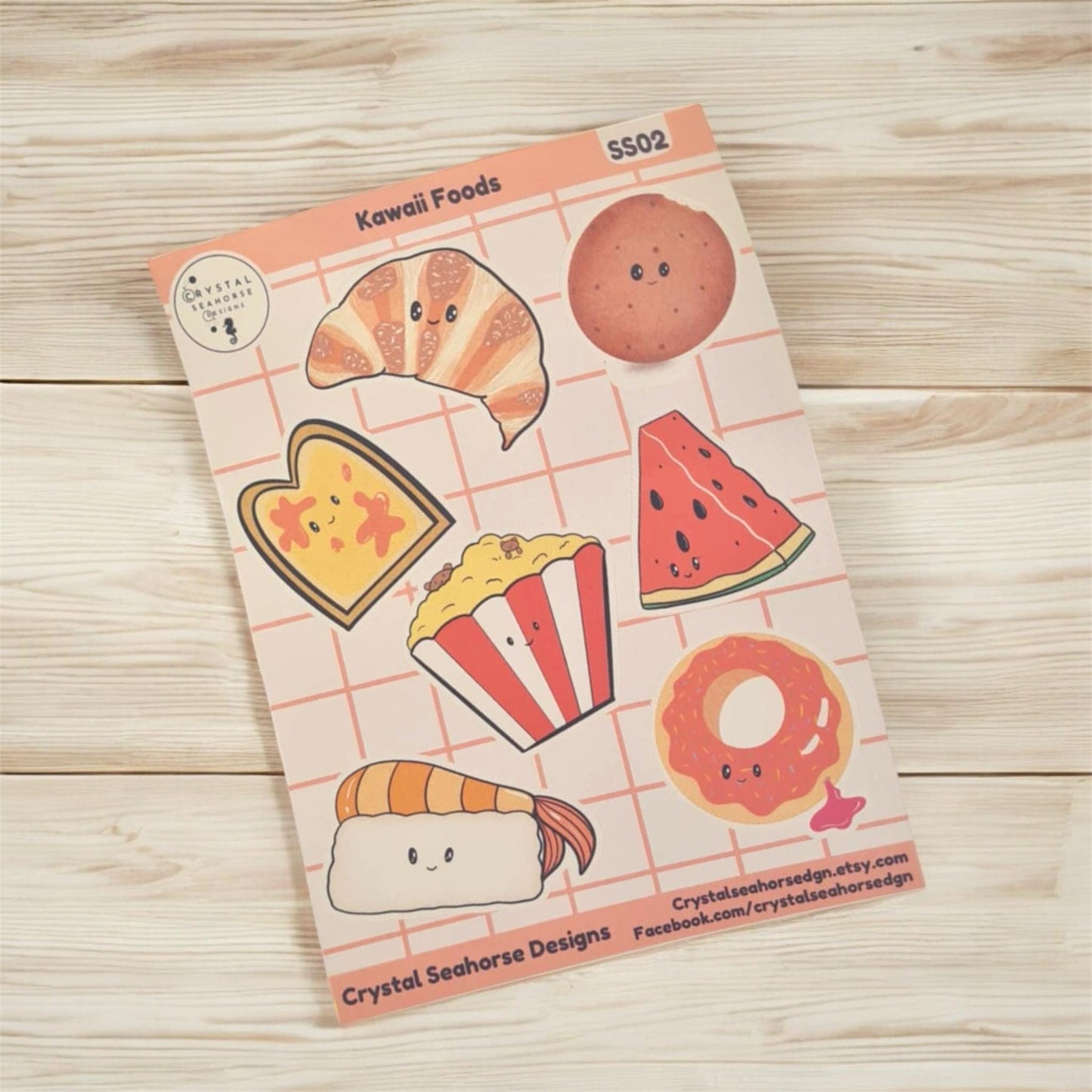 Sheet of kawaii food-themed stickers on a wooden surface