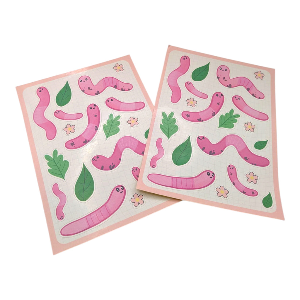 Two sheets of pink worm stickers with green leaves and flowers on a white background