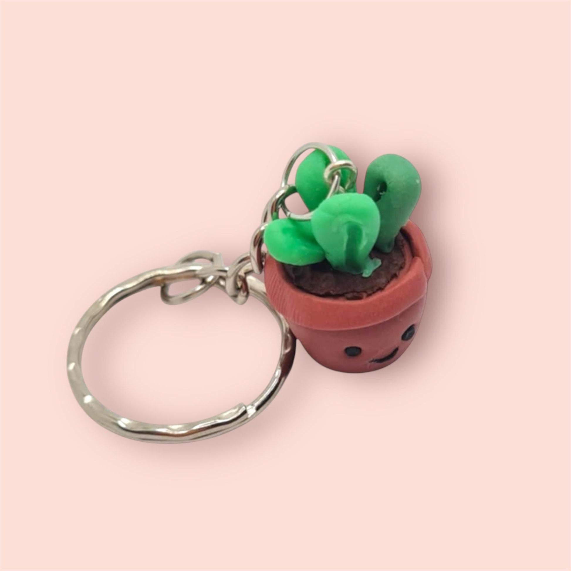 Cactus-shaped keychain on a pink background