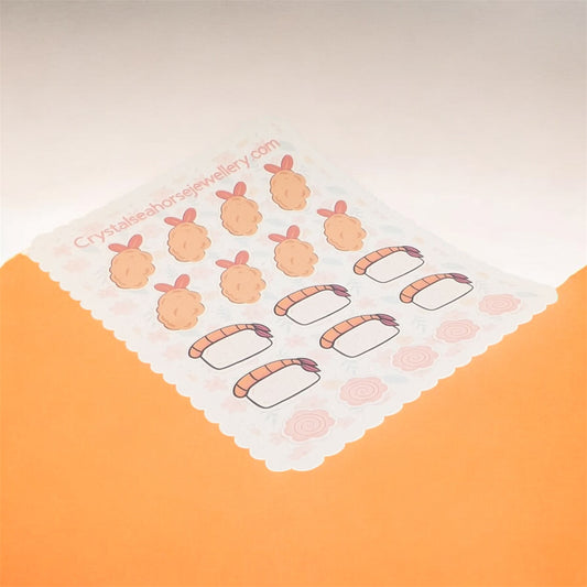 Sheet of cartoon sushi stickers on a white background with 'CrystalShineJewellery.com' printed on it.
