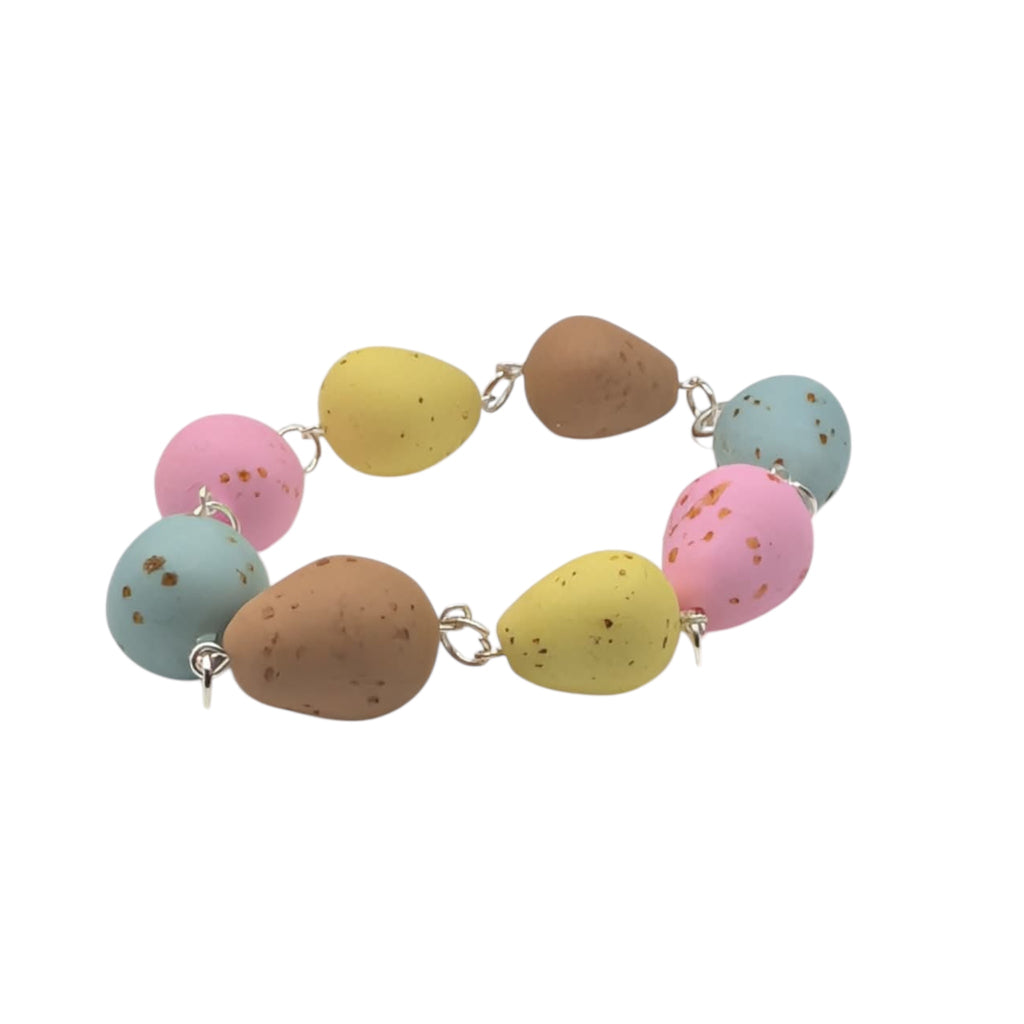 Faux chocolate egg bracelet on white background 