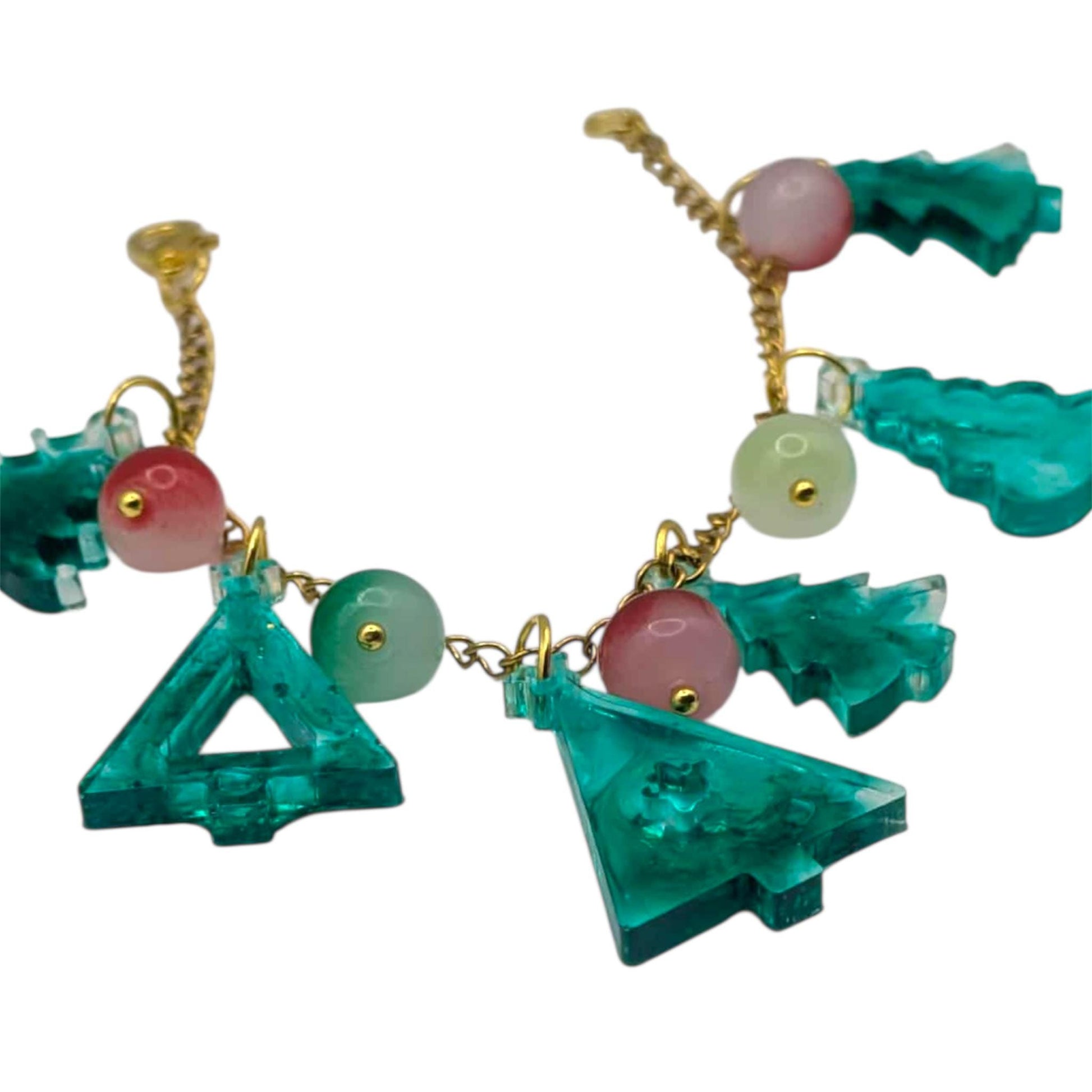 Colorful beaded bracelet with green tree-shaped pendants on a white background