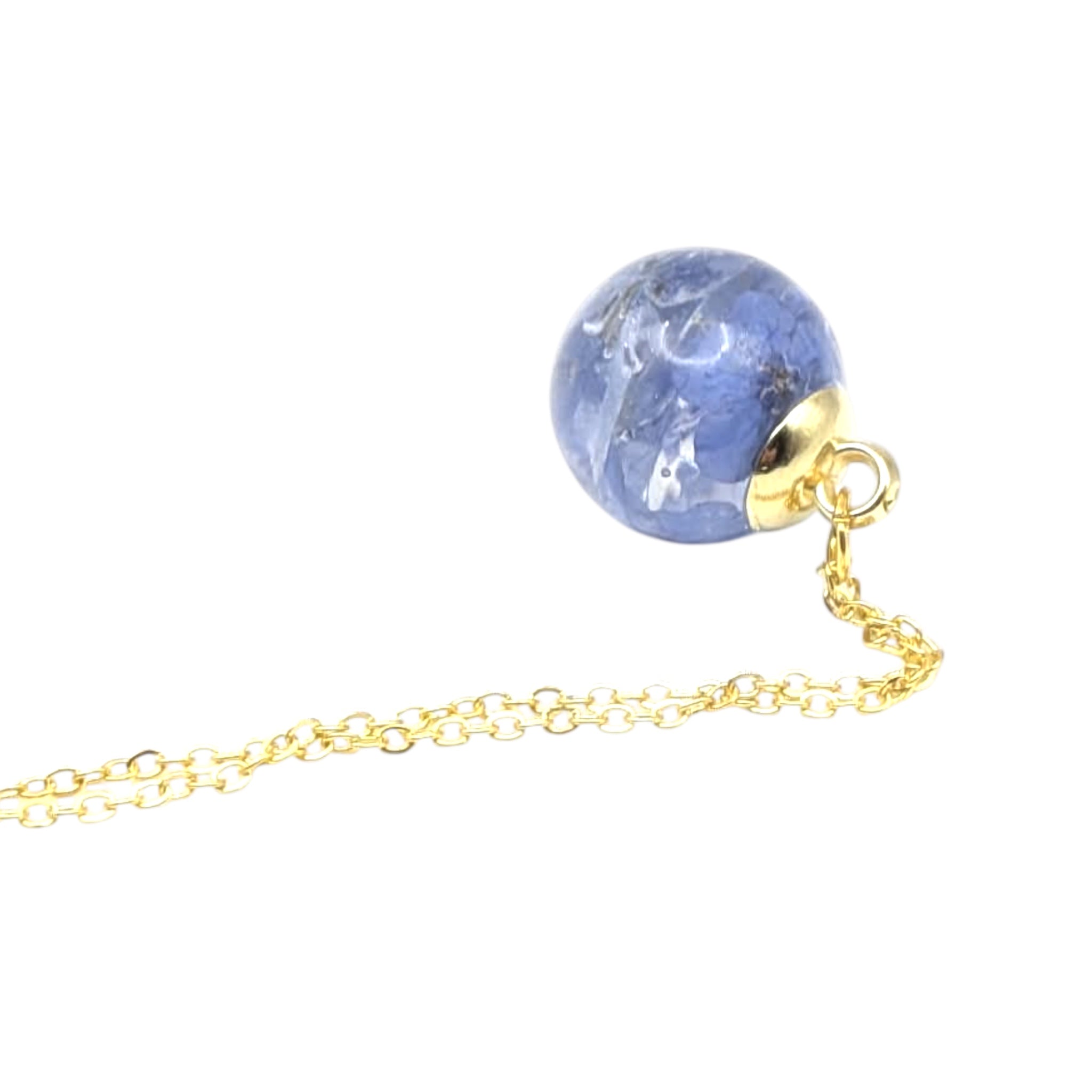 Gold necklace with a blue floral globe on a white background