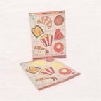Two sheets of cute food-themed stickers on a light pink background