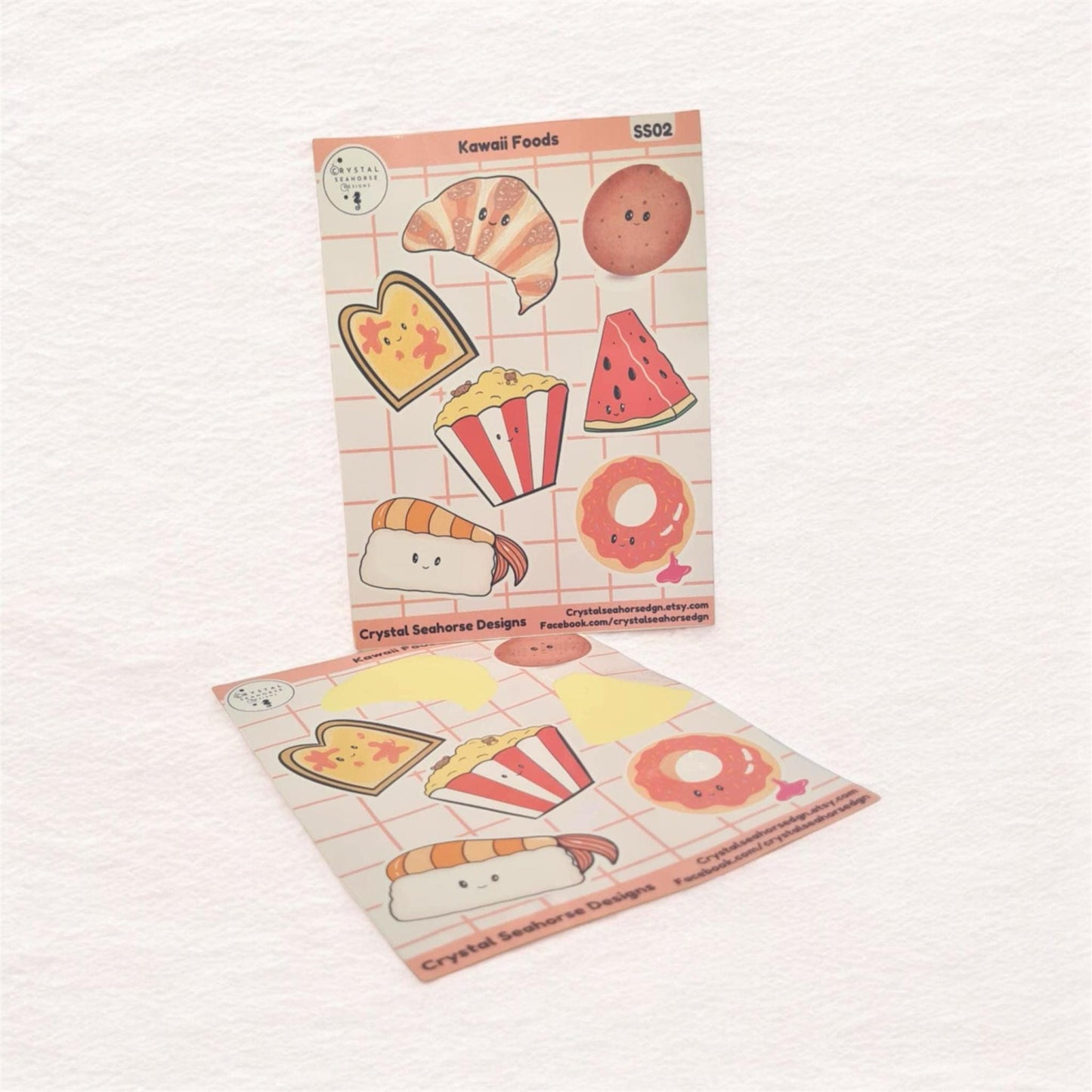 Two sheets of cute food-themed stickers on a light pink background