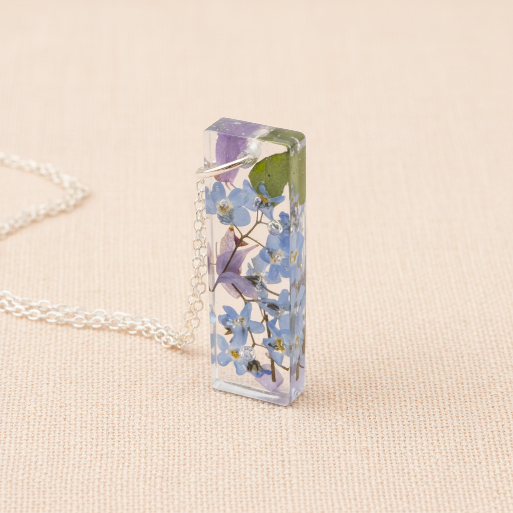 Forget-me-not bar necklace on peach linen