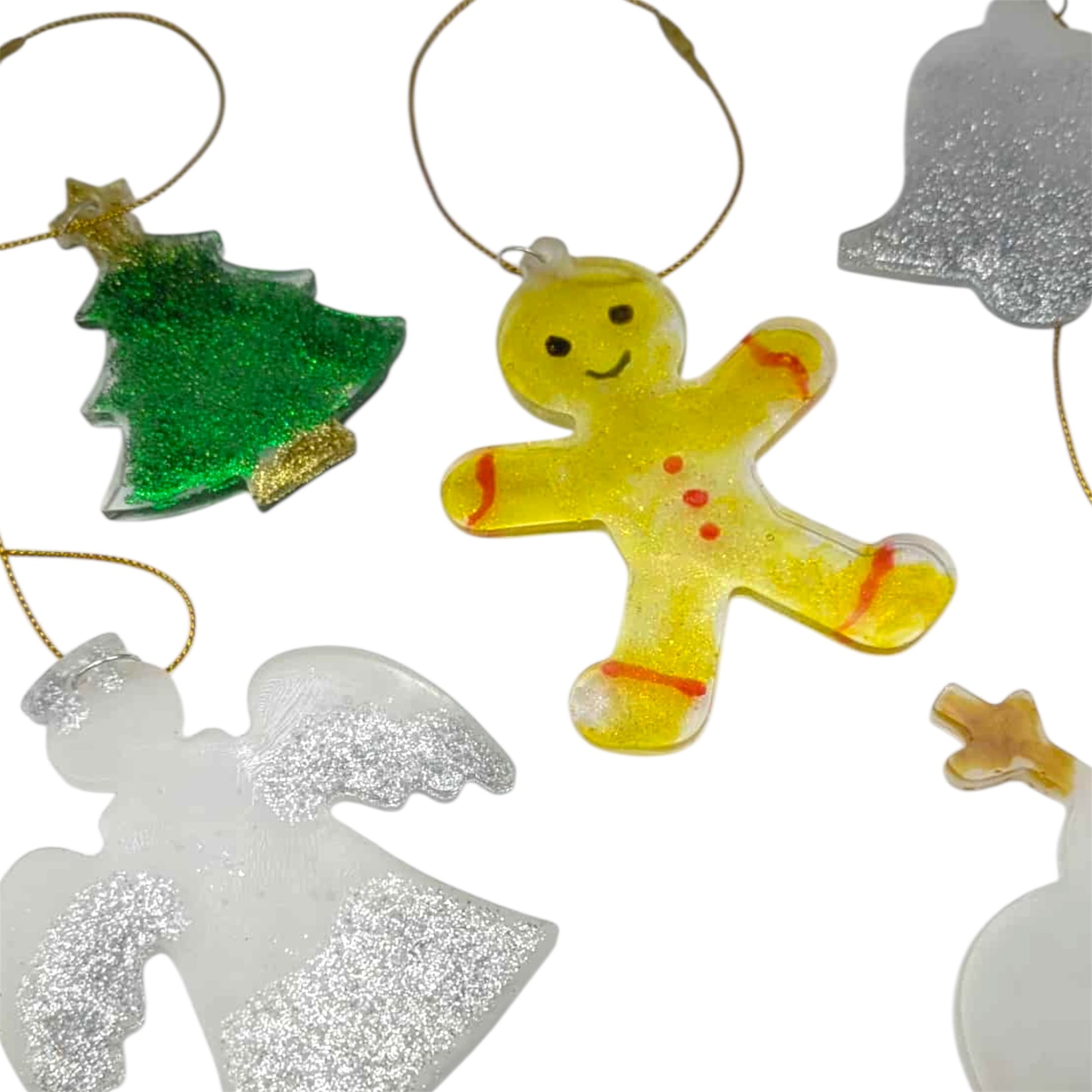 Collection of colorful Christmas ornaments including a gingerbread man, tree, angel, and star on a white background.