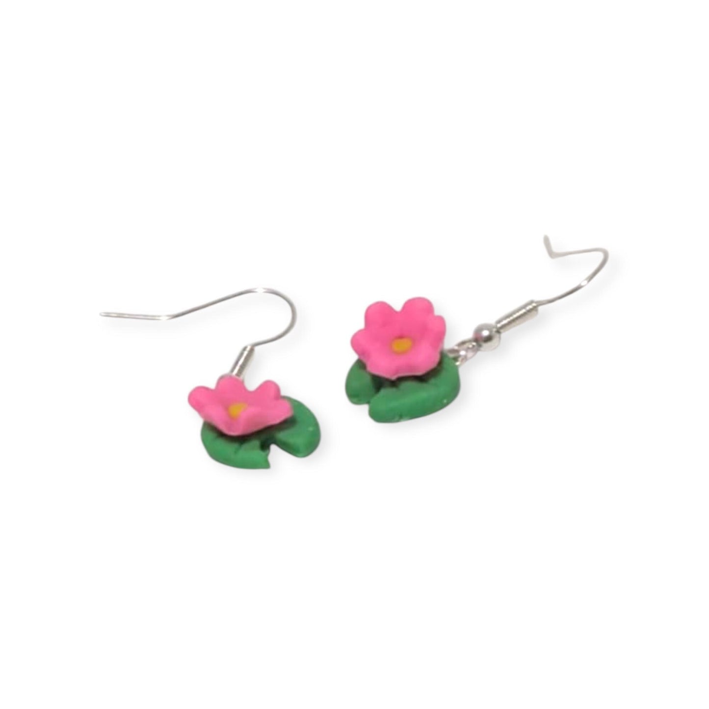 Flower-shaped earrings with pink flowers and green leaves on a white background