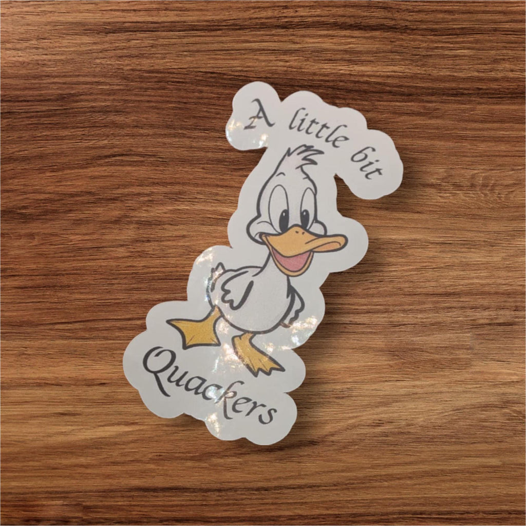 Cartoon duck sticker with text on a wooden surface