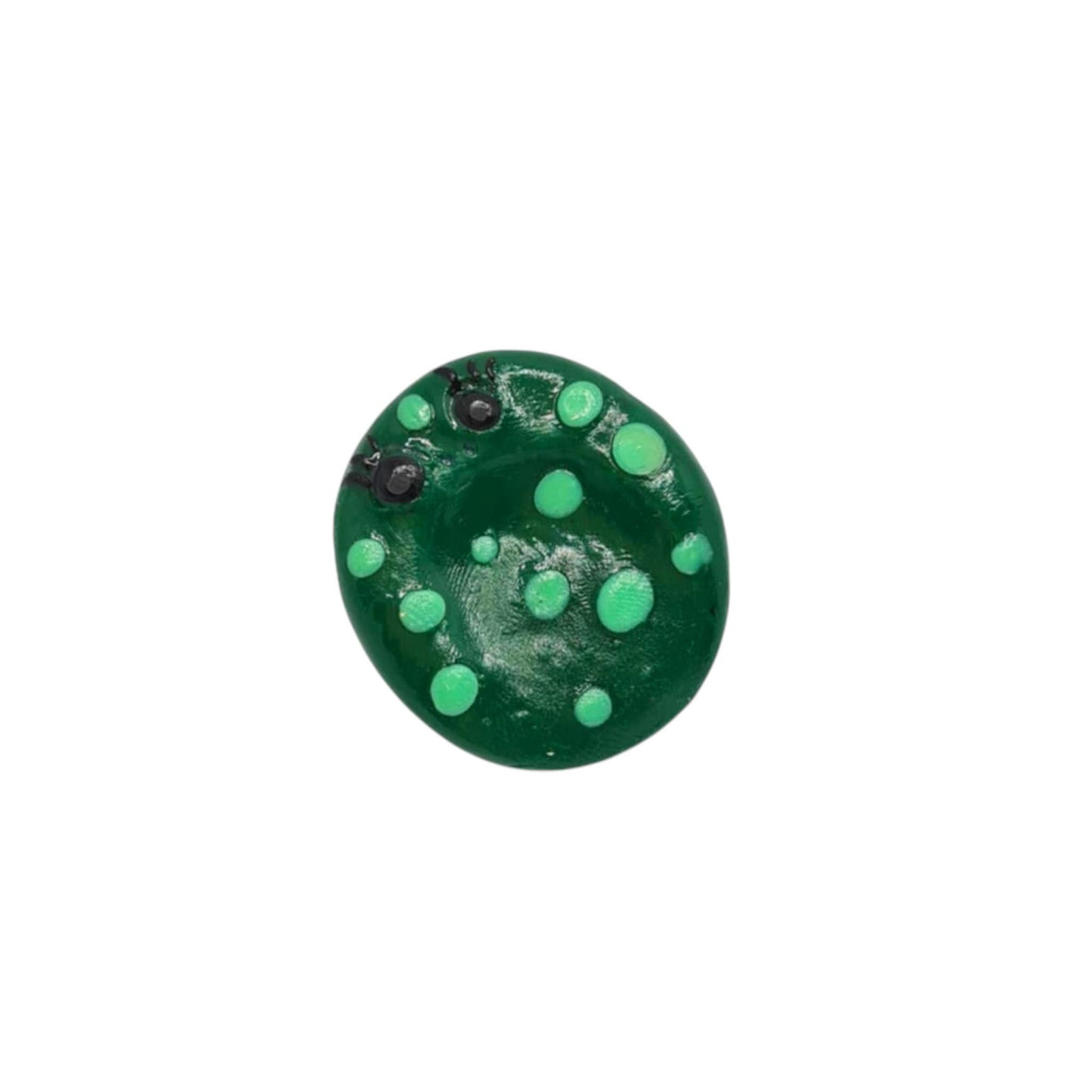 Green circular object with green dots on a white background