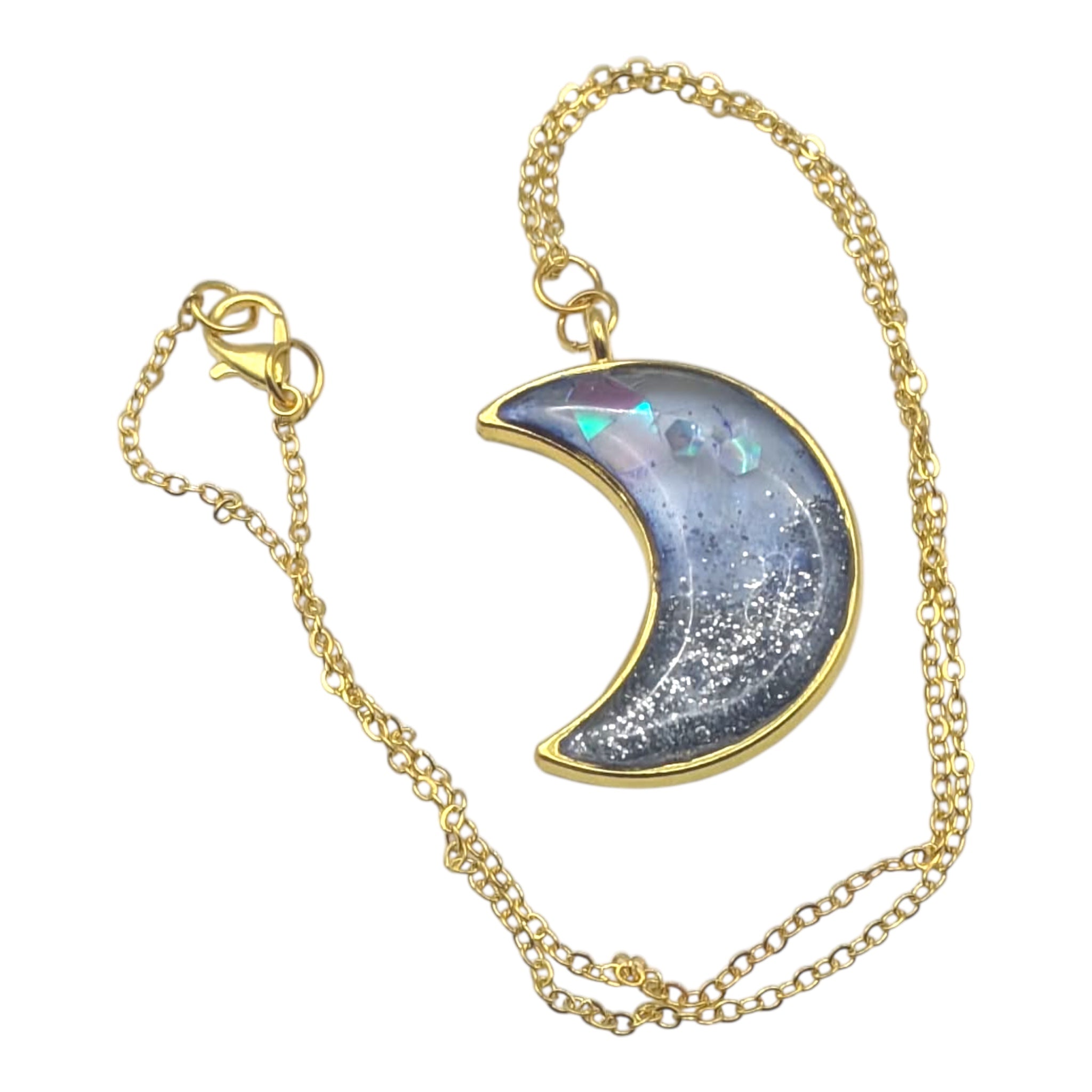 Gold chain necklace with a crescent moon pendant on a white background