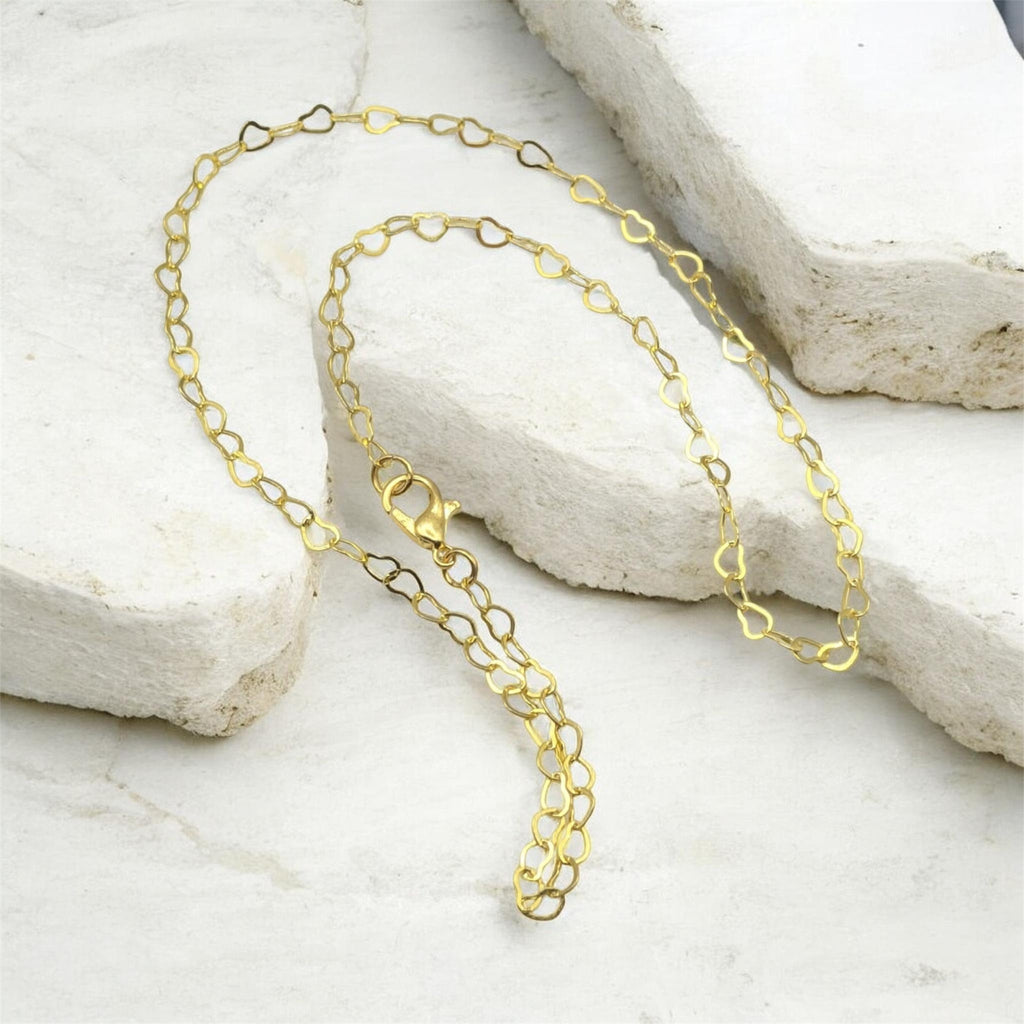 Closeup hollow heart gold chain necklace handmade jewellery UK
