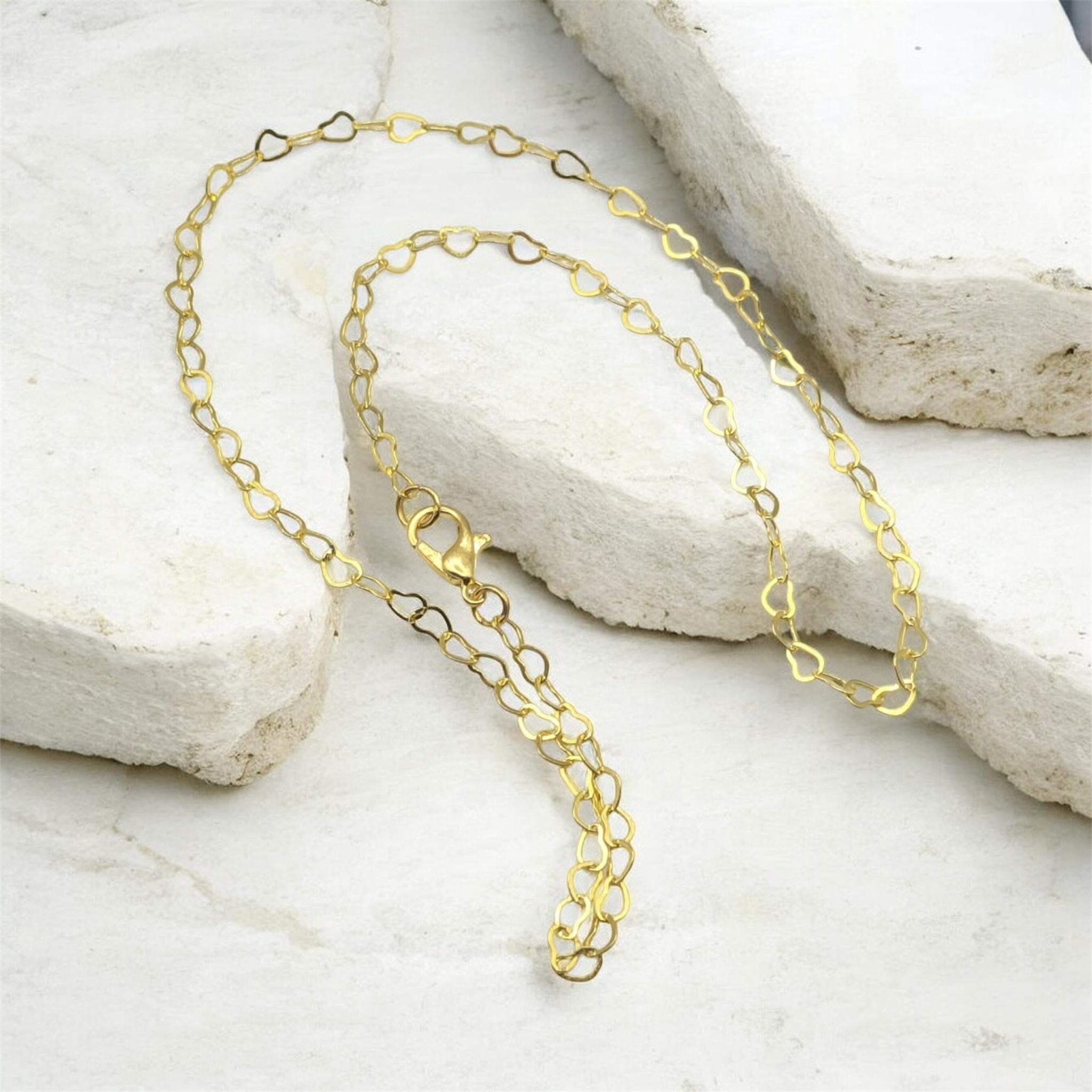 Closeup hollow heart gold chain necklace handmade jewellery UK