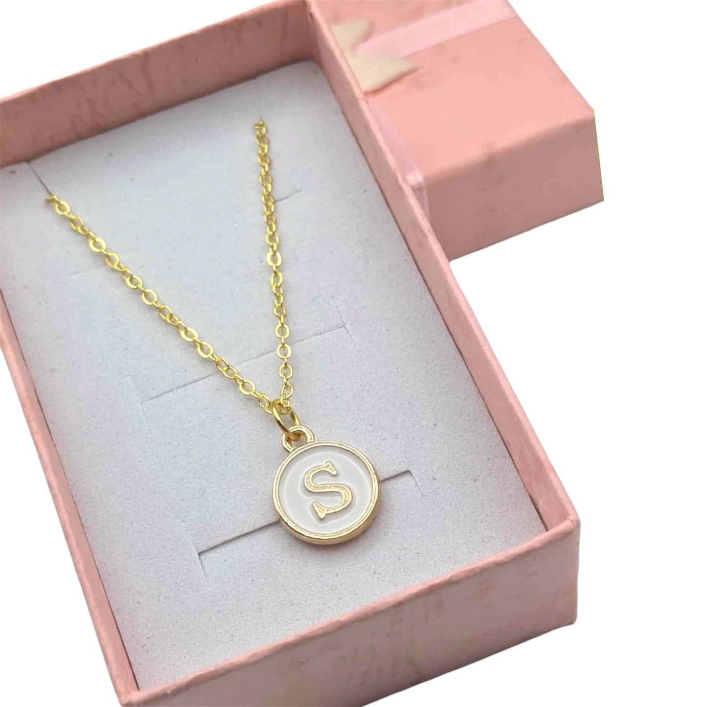 Gold necklace with a 'S' pendant in a pink box