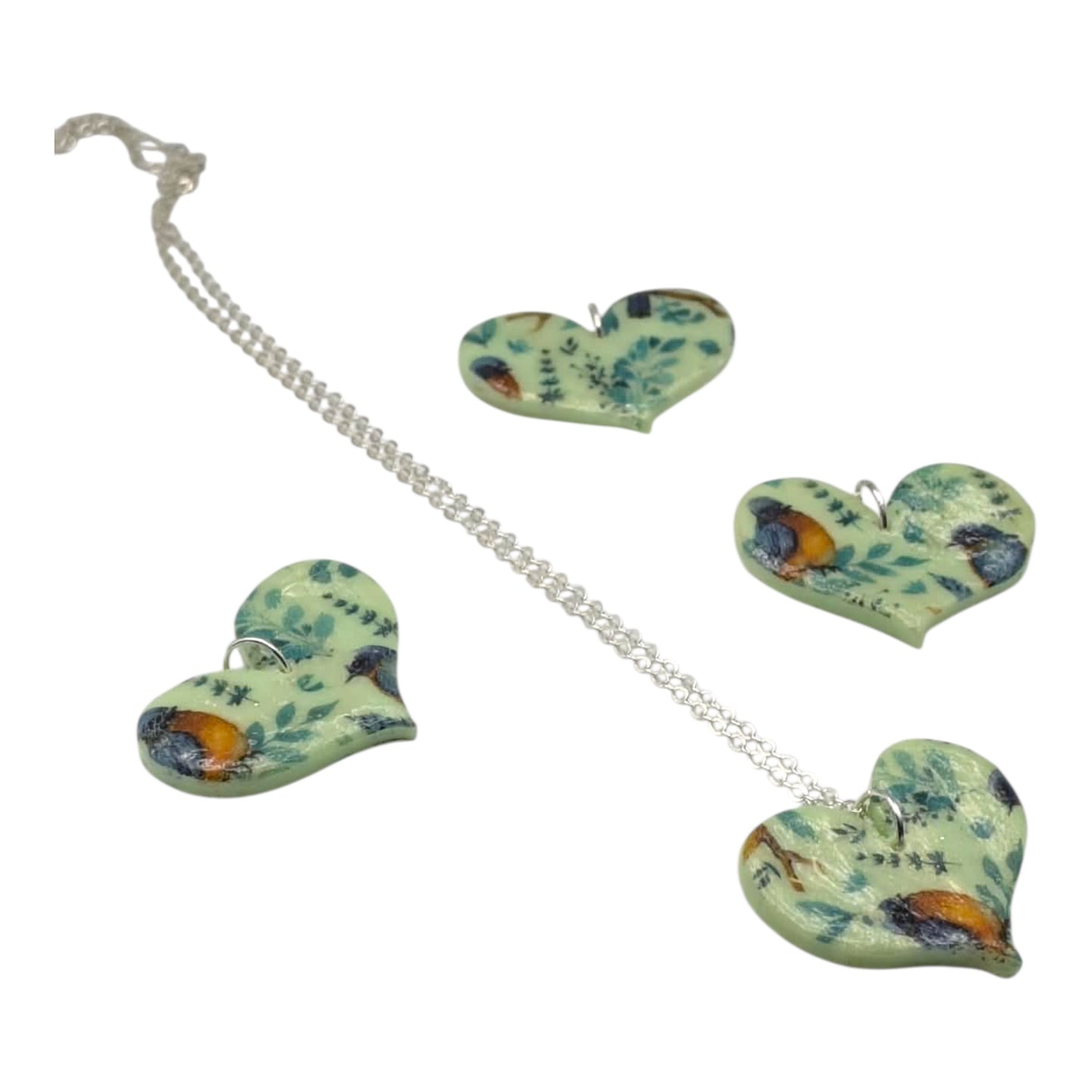 Heart pendants with birds on a white background 