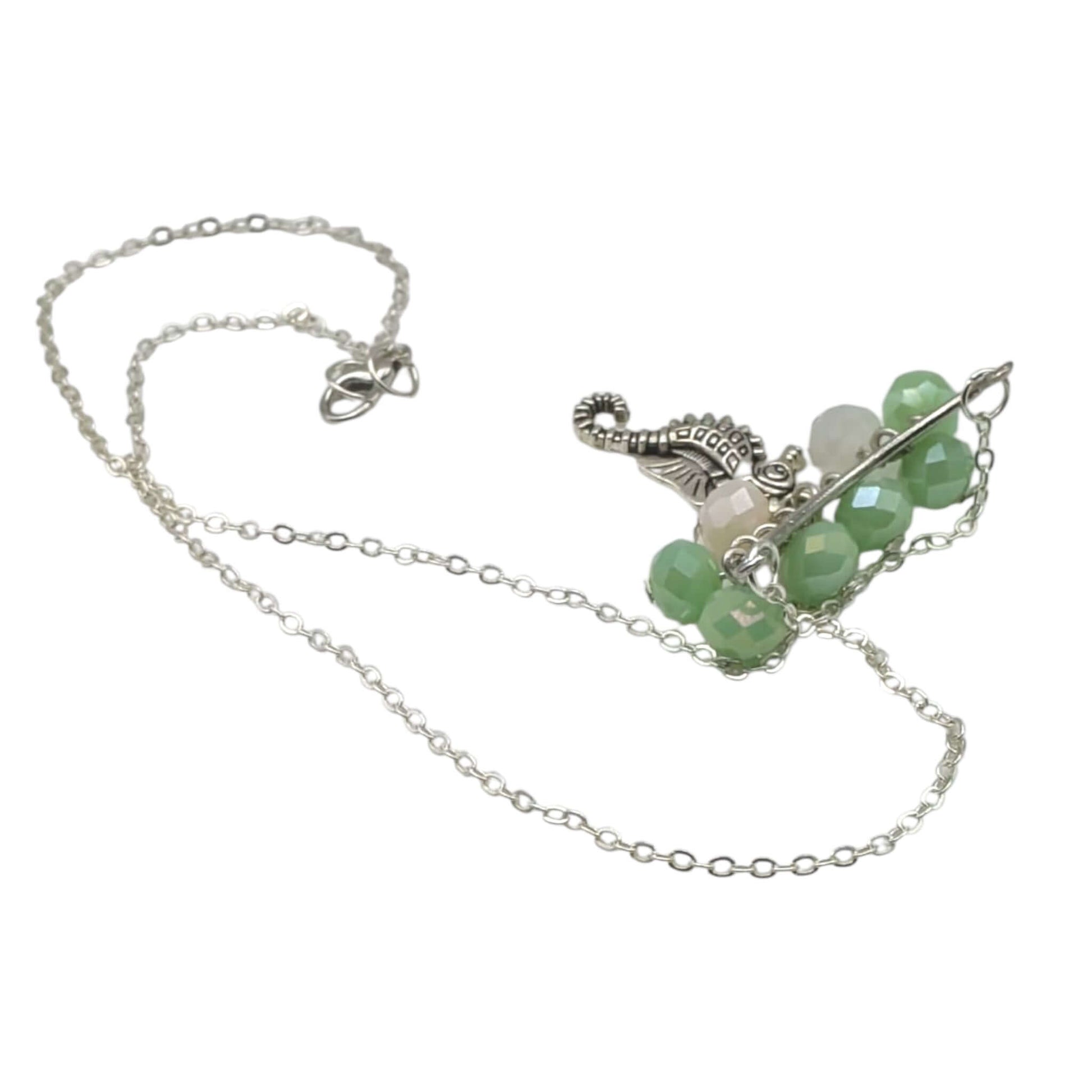 Silver chain seahorse necklace handmade jewellery on white background 