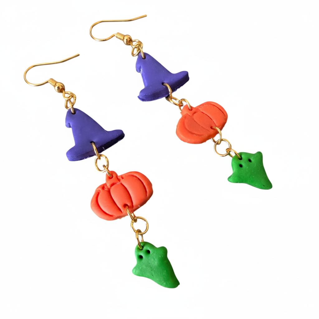 Colorful Halloween-themed earrings with witch hats, pumpkins, and ghosts on a white background.
