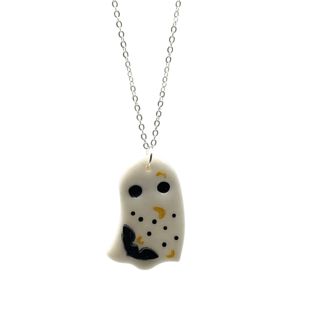 Ghost-shaped pendant on a chain against a white background polymer clay necklace 