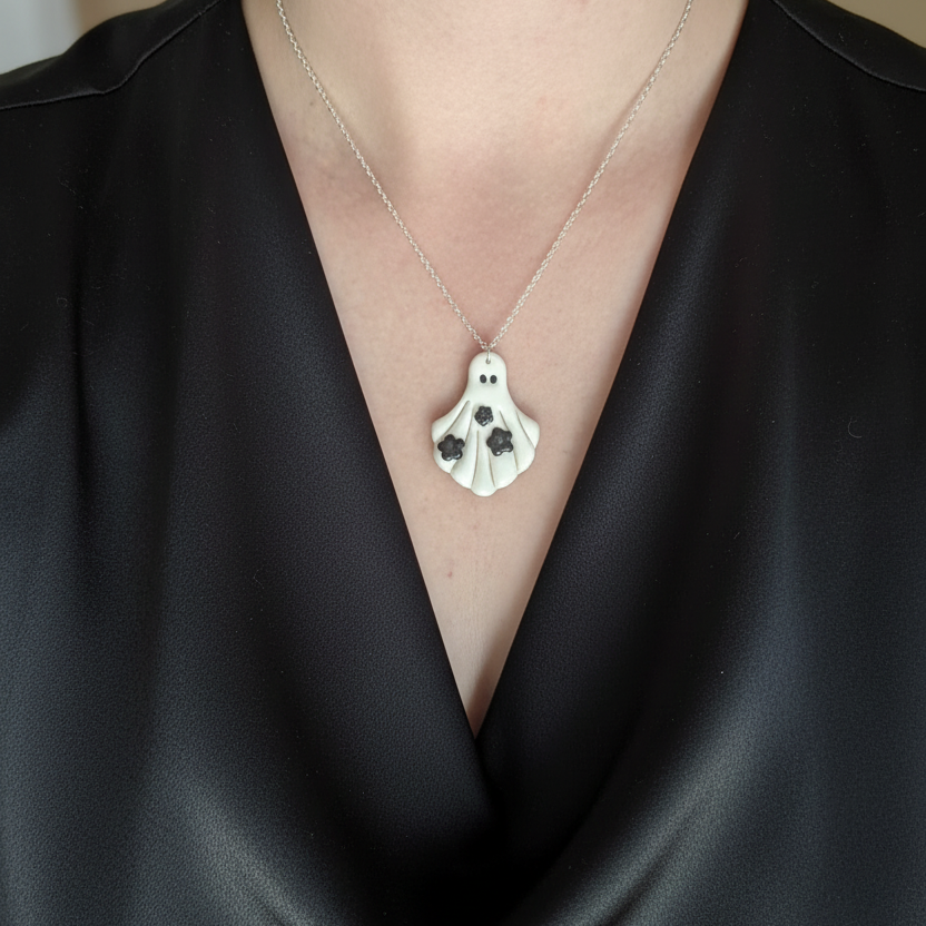Ghost pendant necklace worn on neck with silver chain 