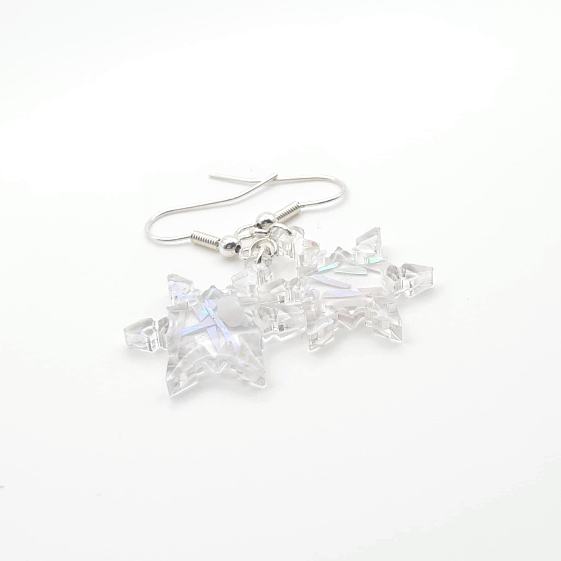 Clear crystal snowflake earrings on a white background