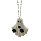Ghost-shaped pendant necklace on a white background