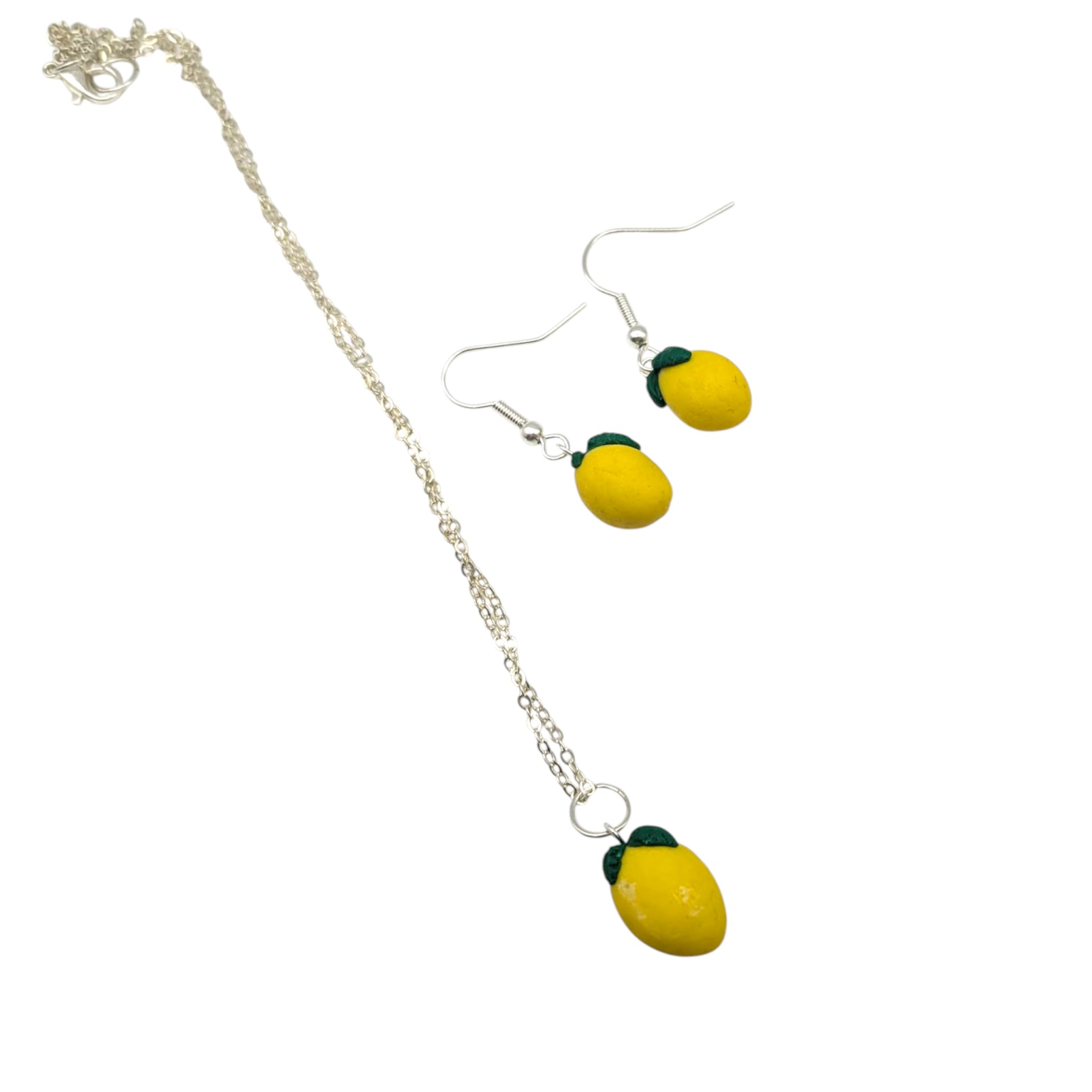 Lemon necklace and earrings, silver plated yellow summer jewellery gift set on white background  