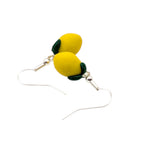 Close up of yellow lemon earrings, handmade polymer clay fruit jewellery.