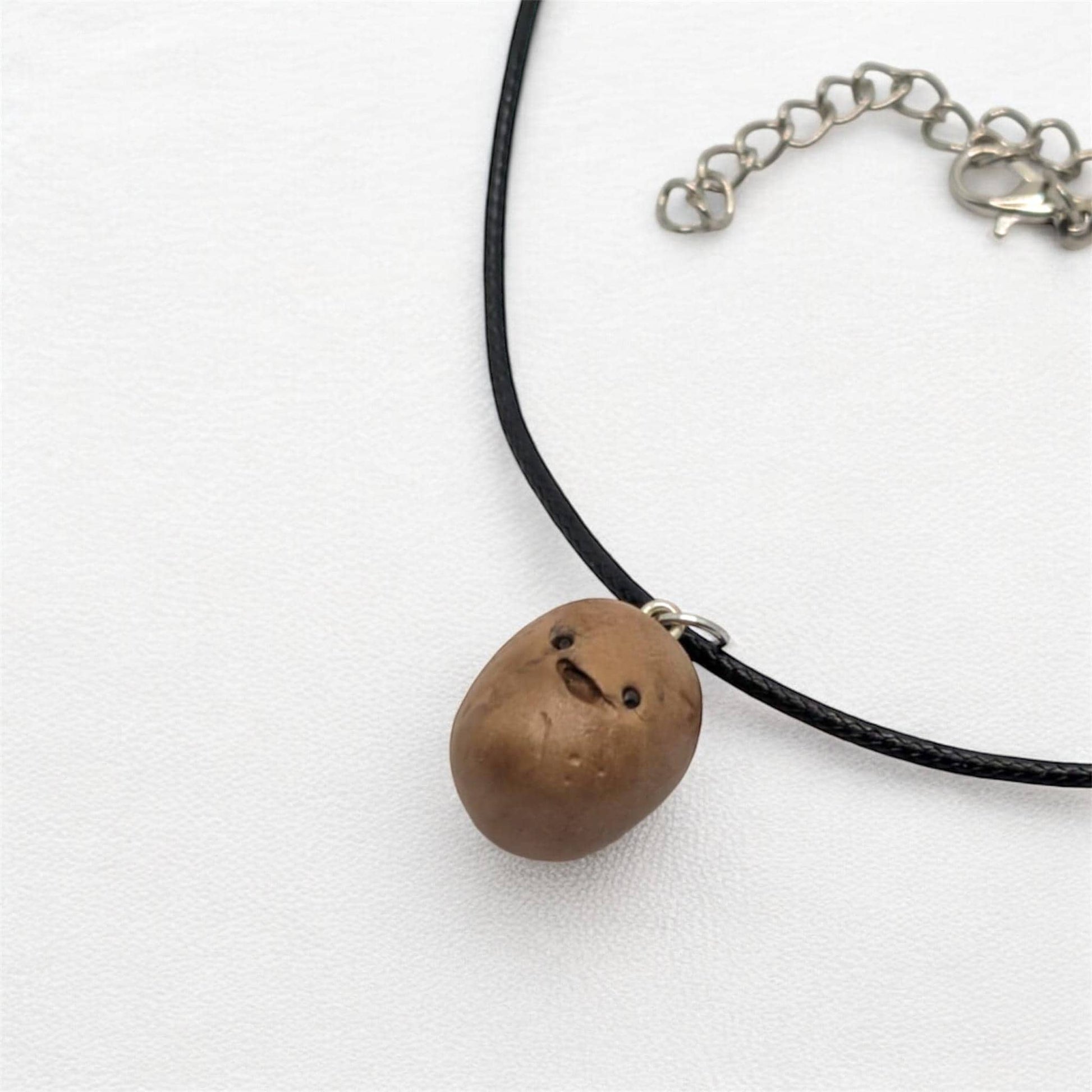 Necklace with a brown potato pendant on a white background