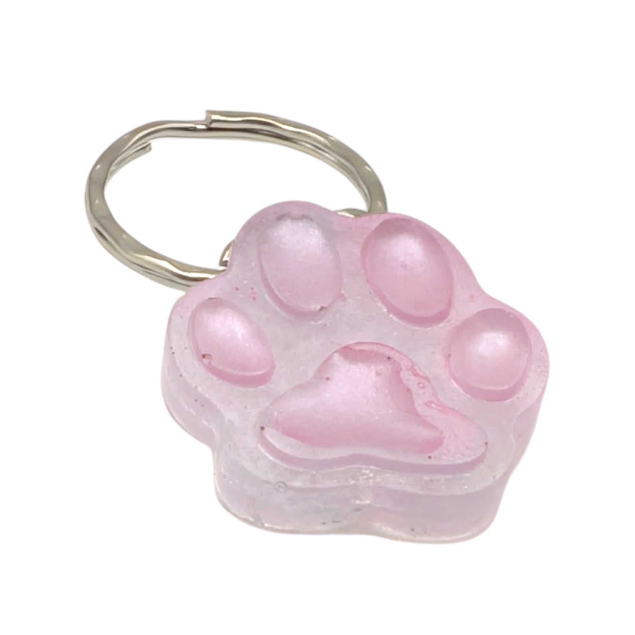 Close up of handmade resin paw print charm on silver keychain 