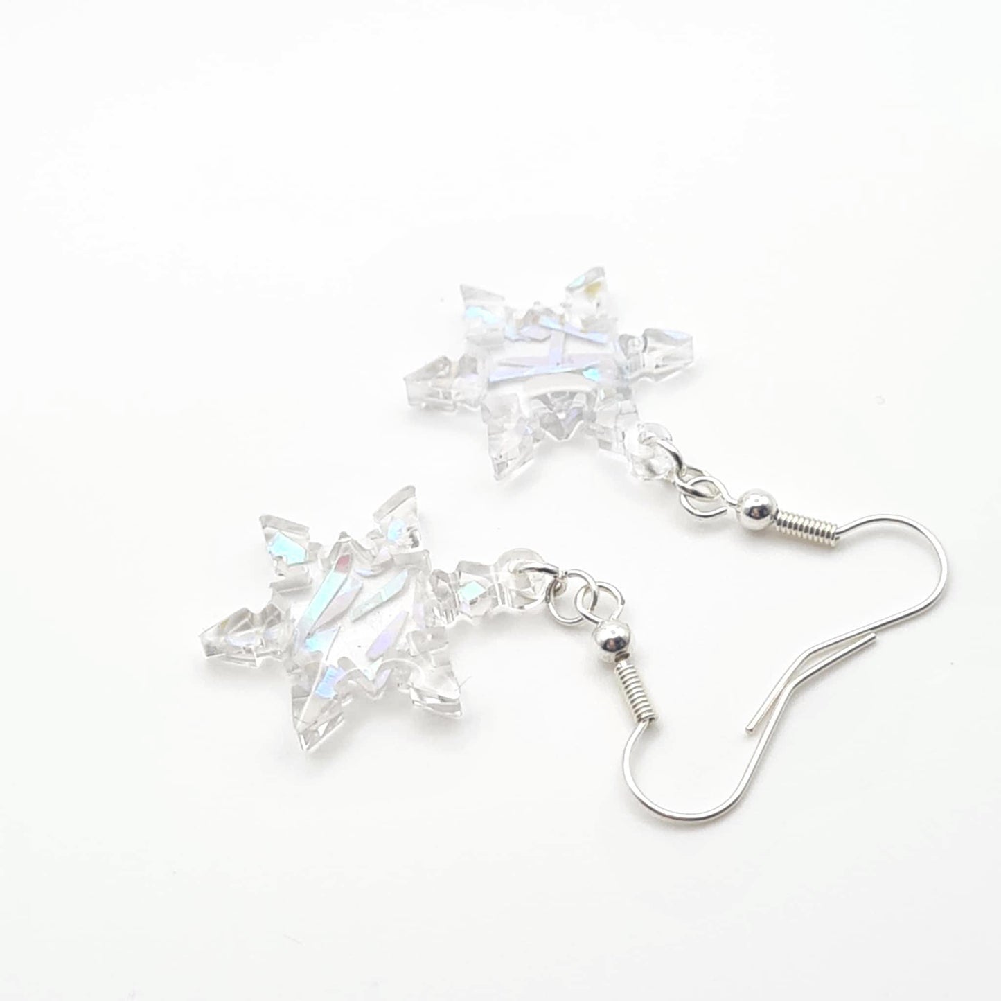 Star-shaped crystal earrings on a white background