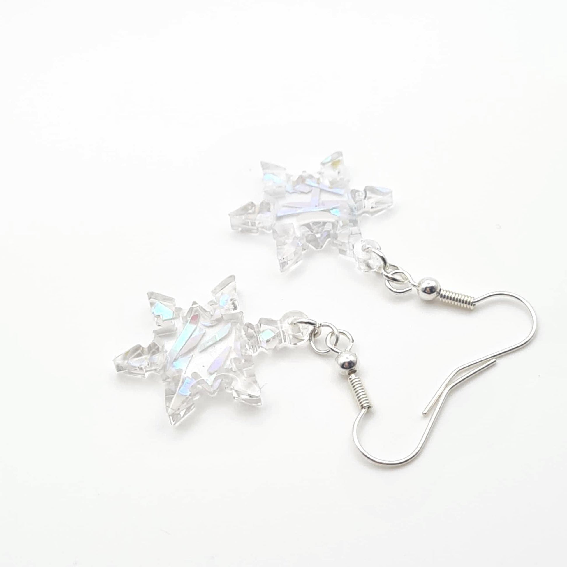 Star-shaped crystal earrings on a white background