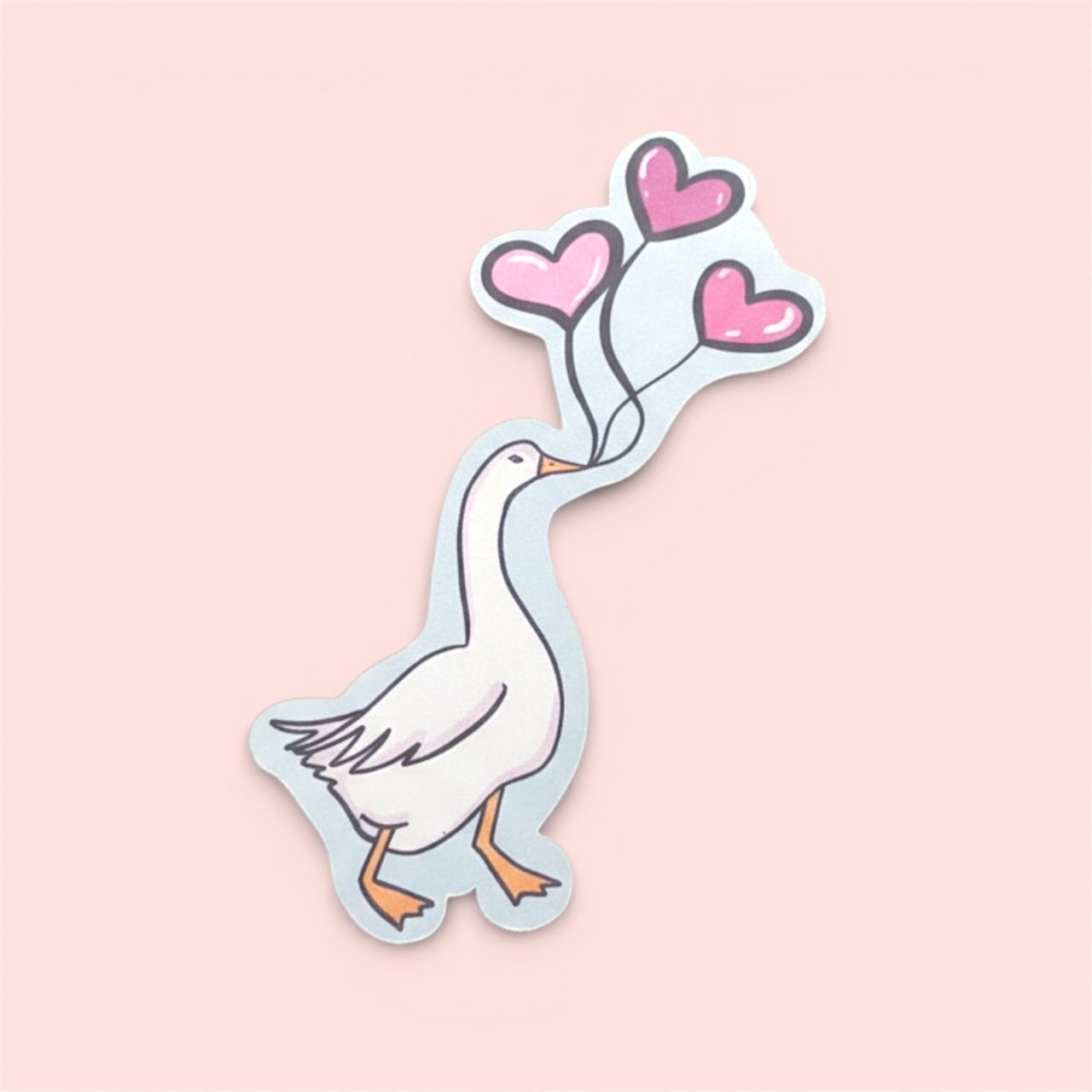 Sticker of a goose holding heart-shaped balloons on a pink background
