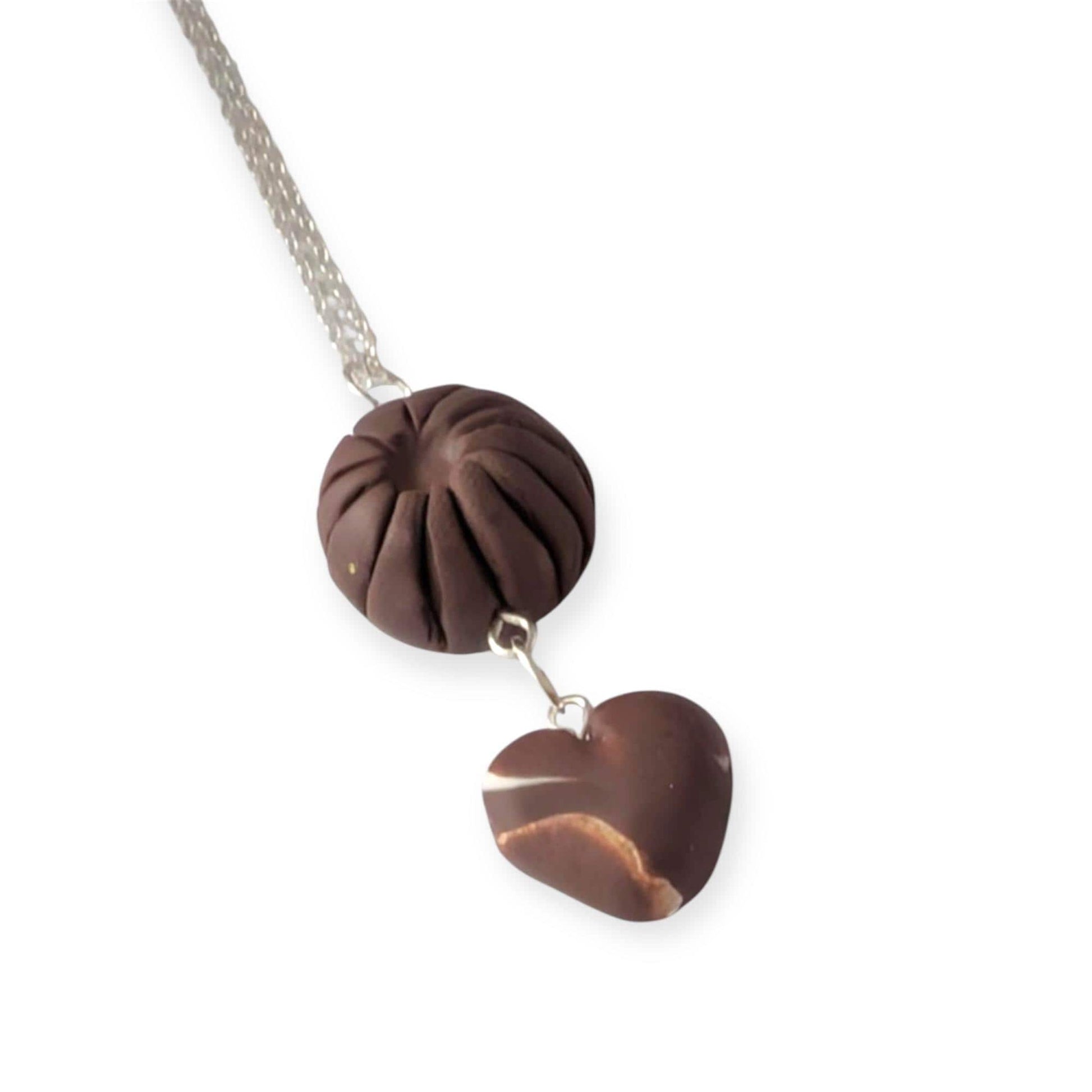 Necklace with a brown heart-shaped pendant on a white background