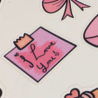 Sticker with 'I Love You' text on a pink background with decorative elements.
