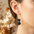 Black cat polymer clay earrings being worn lifestyle shot