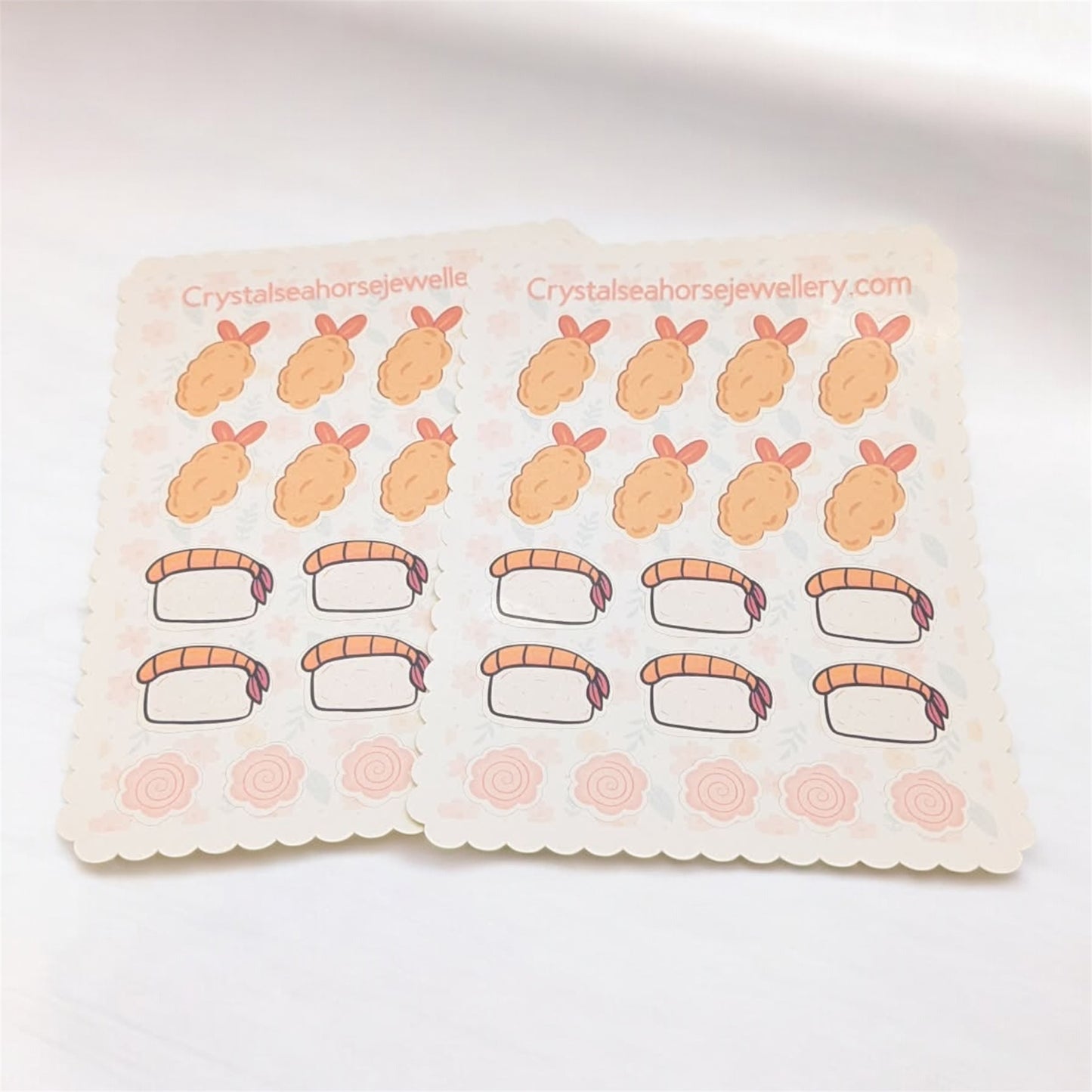 Sheet of stickers with cartoon sushi designs on a white background