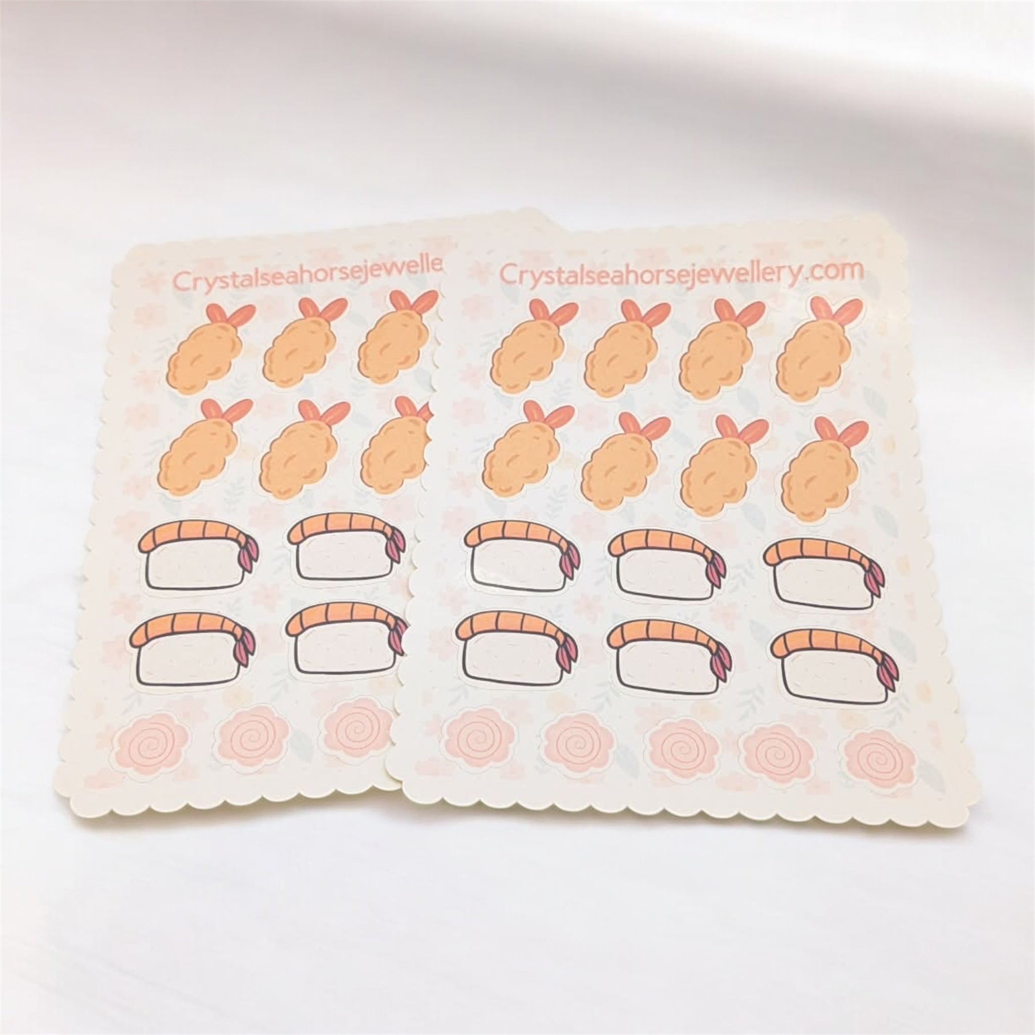 Sheet of stickers with cartoon sushi designs on a white background